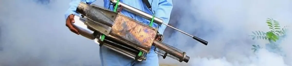 Fumigation technician using a fogger for deep pest treatment in Little Rock, AR